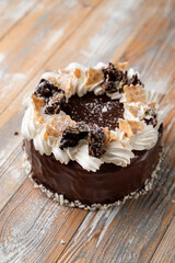 Soviet cake with buttercream swirls with chocolate crumpets, top view photography for a coffee shop menu