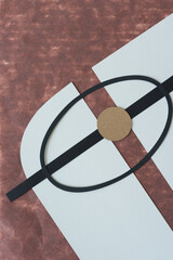 background with black paper oval ring, brown paper circle, and black paper stripe on gray card stock shapes and brown tissue paper