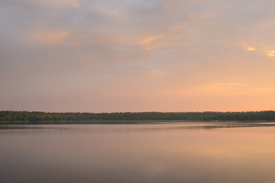 Early morning on the lake. Vanilla sky, calm water. Beautiful nature landscape