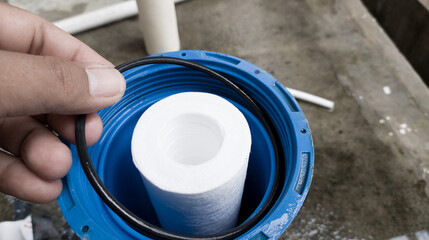 The man hold the Oring Seal of the water filter catridge. process change water filter catridge.