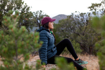Woman taking a break from hiking - obrazy, fototapety, plakaty