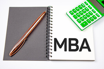 MBA - Master of Business Administration text on notepad with calculator.Education concept.