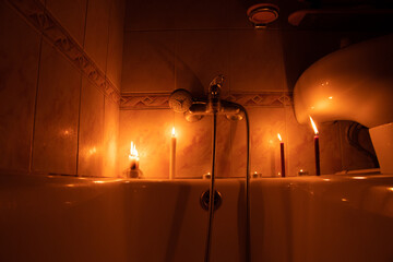 Candles in the bathroom in a dark apartment in Ukraine, Ukraine without electricity due to the war