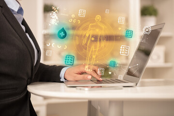 Doctor working on laptop with healthcare concept