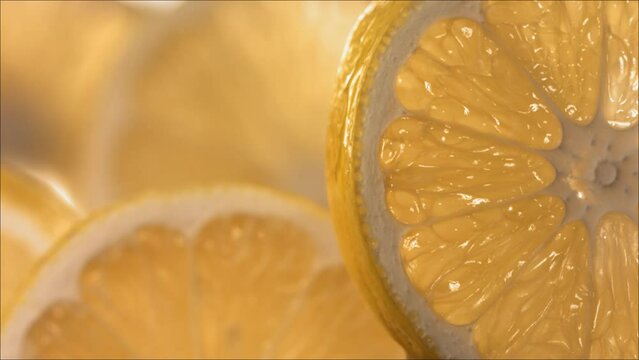 Drop of Water flow down the surface of a ripe juicy Lemon slice. Slow Motion 4K