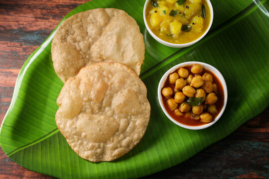 Puri Bhaji North Indian Poori with aalu bhaji , aalu sabji potato spicy recipe breakfast food a deep fried bread of whole wheat flour. poori masala in restaurant Kerala, India, Sri Lanka.
