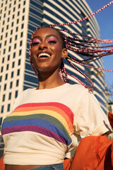 Obraz premium Portrait of young non-conforming with braids smiling in the city