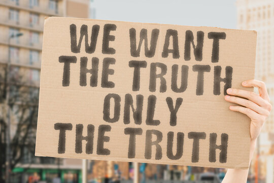The phrase " We want the truth..Only the truth " is on a banner in men's hands with blurred background. Inform. Fake. Politic. Information. Resistance. Demonstrate. Trust. Morality. Convention