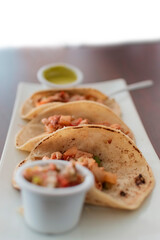 Close-up of Mexican chicken tacos served, Three Mexican chicken tacos with salsa and pico de gallo served on the table, View of chicken tacos served on the table