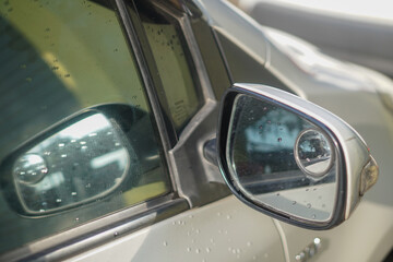 a car rearview mirror wet after rain.