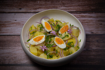 Recipe Potato salad with coriander, hard-boiled eggs and red onions. High quality photo