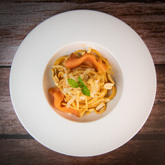 Recipe for homemade spaghetti with tomato sauce, smoked salmon, roasted peanuts and parmesan. High quality photo