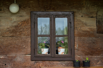 Croatia, October 20,2022 : Rustic style aged window at rural home wall.
