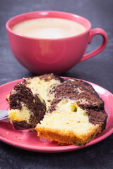 Fresh baked yeast cake with cocoa, cup of cappuccino. Delicious dessert