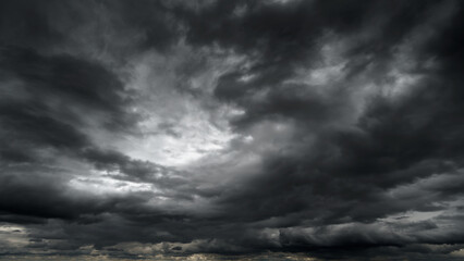 dark dramatic sky with black stormy clouds before rain or snow as abstract background, extreme...