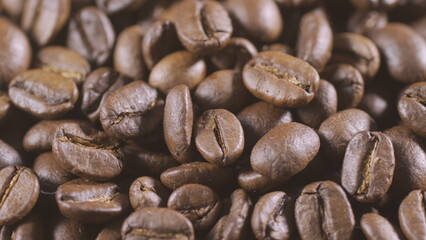 Slow rotation of the heap of coffee beans. Close up of coffee beans. Loopable rotation. Rotates plate with coffee beans. 4K