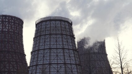 Dark hot smoke coming out of an industrial chimney of a chemical plant.
