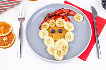 Santa Claus made from pancakes, banana and strawberries. Christmas or New Year food.