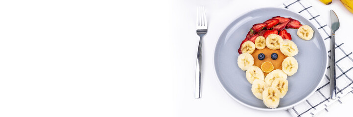 Banner with space to text Santa Claus from pancakes, banana and strawberries. Christmas or New Year food.