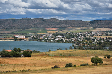 View of  Arcos de la Frontera, small town in Spain on the lake shore  (Arcos water reservoir) . 