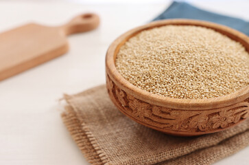 Top view image of quinoa in wooden plate on table