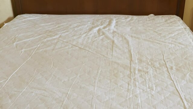Changing blanket on the bed