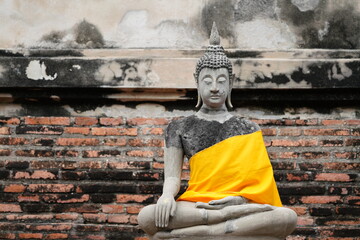 Ruins of pagodas, monks and walls that remain of Wat Yai Chaimongkol, Ayutthaya, Thailand, were...