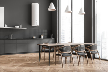 Grey kitchen interior with eating table and chairs, panoramic window