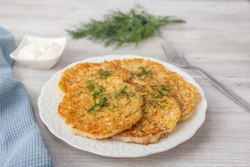Potato pancakes with sour cream and dill.
