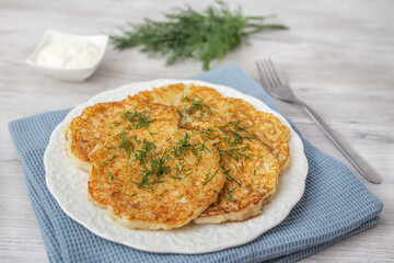Potato pancakes with sour cream and dill.