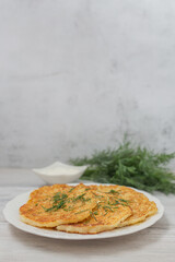 Potato pancakes with sour cream and dill.