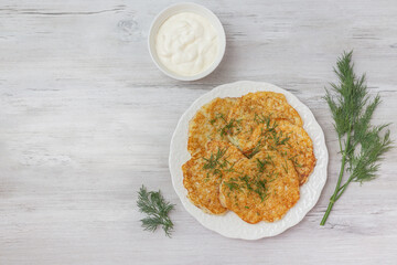 Potato pancakes with sour cream and dill.