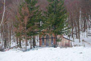 Santissimo Salvatore church on the snow-covered Laceno lake