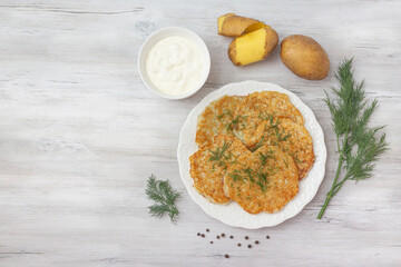 Potato pancakes with sour cream and dill.