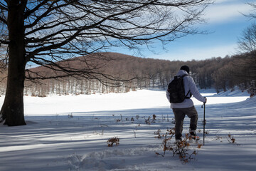 Hiker on the summit of a mountain with snow