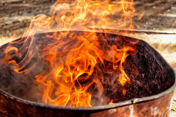 Burning fire in a barrel close-up. Bright flame. Open flame heating. Problems with heating and gas.