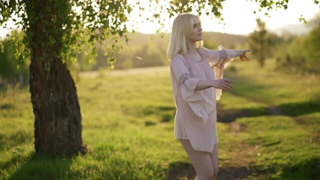 4kk slow motion of young girl enjoy the nature relax freedom concept Young beautiful girl happily Dancing in circles in the grass in the forest full of flowers.