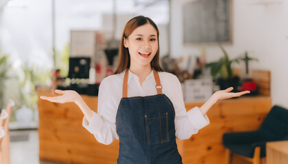 Opening a small business, AHappy Asian woman in an apron standing near a bar counter coffee shop, Small business owner, restaurant, barista, cafe, Online, SME, entrepreneur, and seller concept