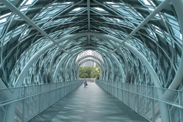 Foto op Canvas Scenic view of the pedestrian bridge Saloma Link connecting Kampung Baru with Ampang road in Kuala Lumpur. A person can seen walking through the bridge. © gracethang