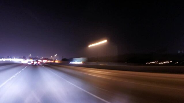 Time Lapse Panning Shot Of Vehicles Moving Together On Busy Highway In City At Night - Los Angeles, California