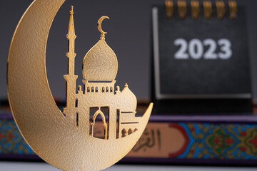 close up of  2023 desk calendar and metal crescent and mosque ramadan decoration item