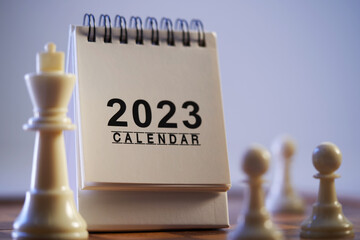 chess pieces and desk calendar 2023