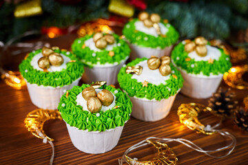 Christmas Cupcakes with hazelnuts on a background of glowing garlands