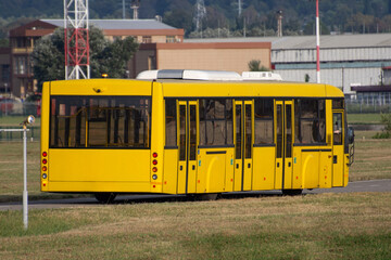 Fototapeta na wymiar Yellow shuttle bus to transport people at the airport to the flight.