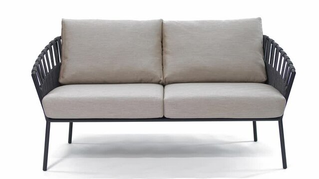 Beautiful comfortable sofa with light cushions and designer rope weave. Insulated. White background