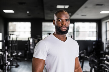 Sporty smiling african man resting, having break after doing exercise.