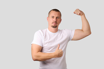 Fototapeta premium Portrait of a strong man posing on white background