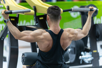 Fitness Workout: Boy doing Exercises in Class with Shoulder Gym Equipment