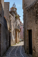 Fototapeta na wymiar Erice, Sicily, Italy - July 10, 2020: Sicilian souvenirs. Ancient, typical narrow and cobblestone street in Erice, Sicily, Italy