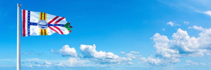 Tampa, USA - flag waving on a blue sky in beautiful clouds - Horizontal banner